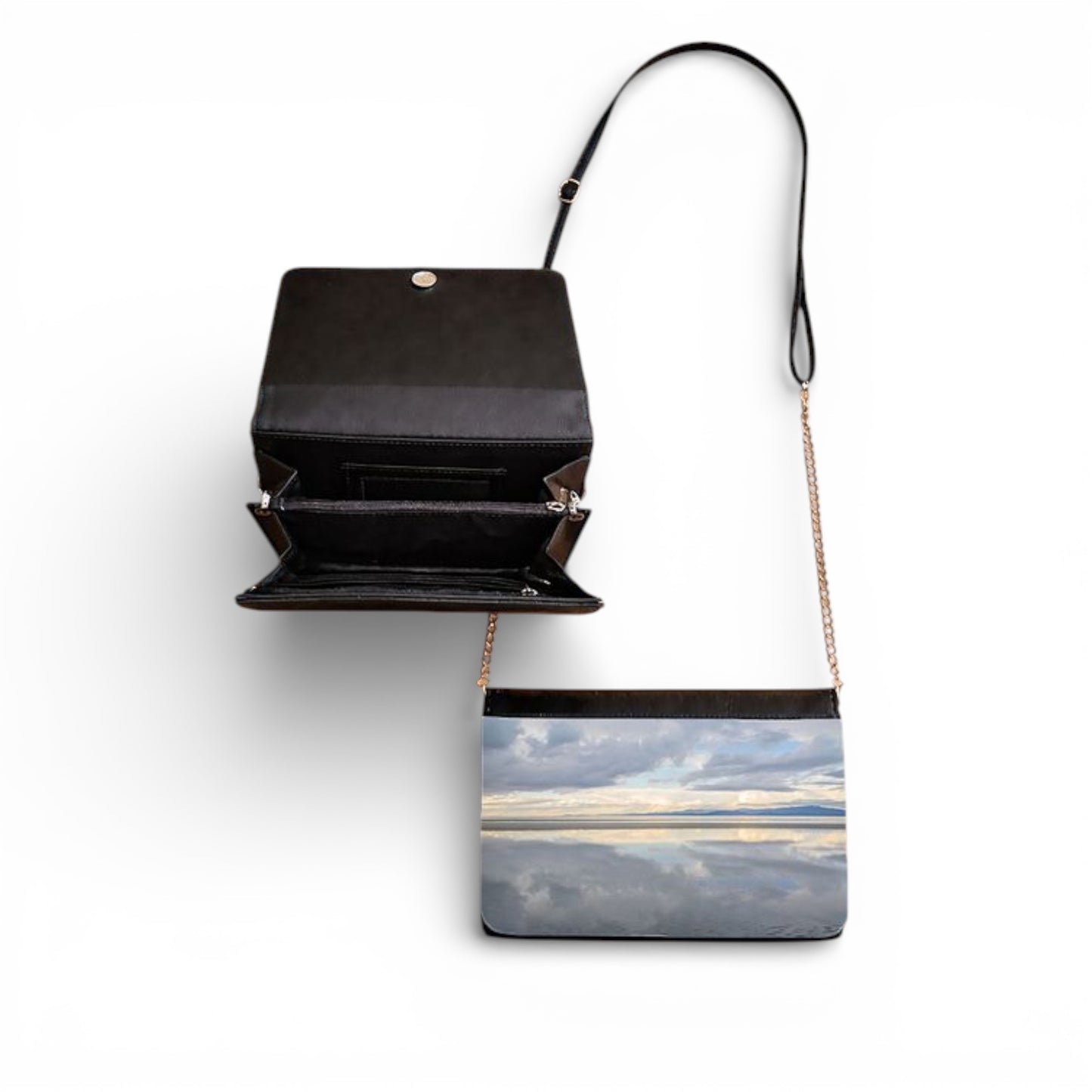 Black handbag with a scenic design on a white background