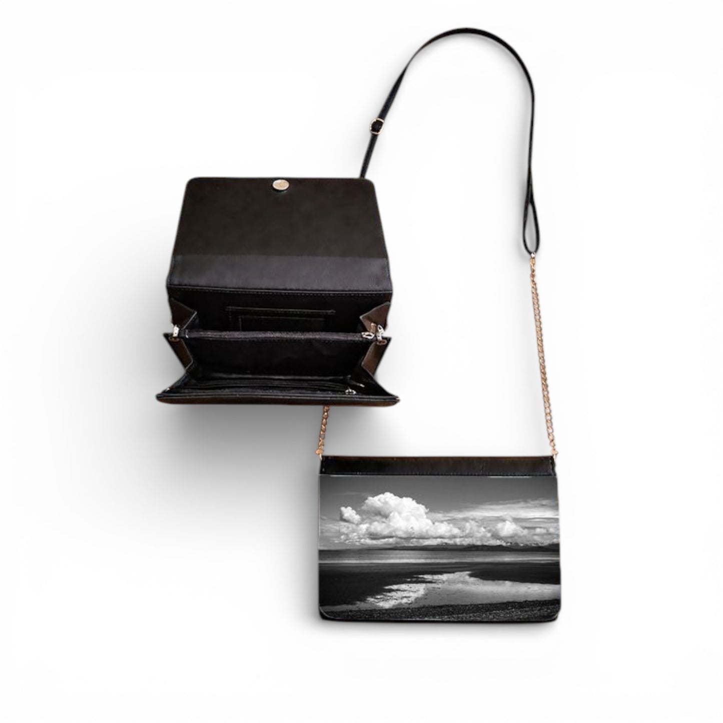 Black handbag with a scenic print on a white background