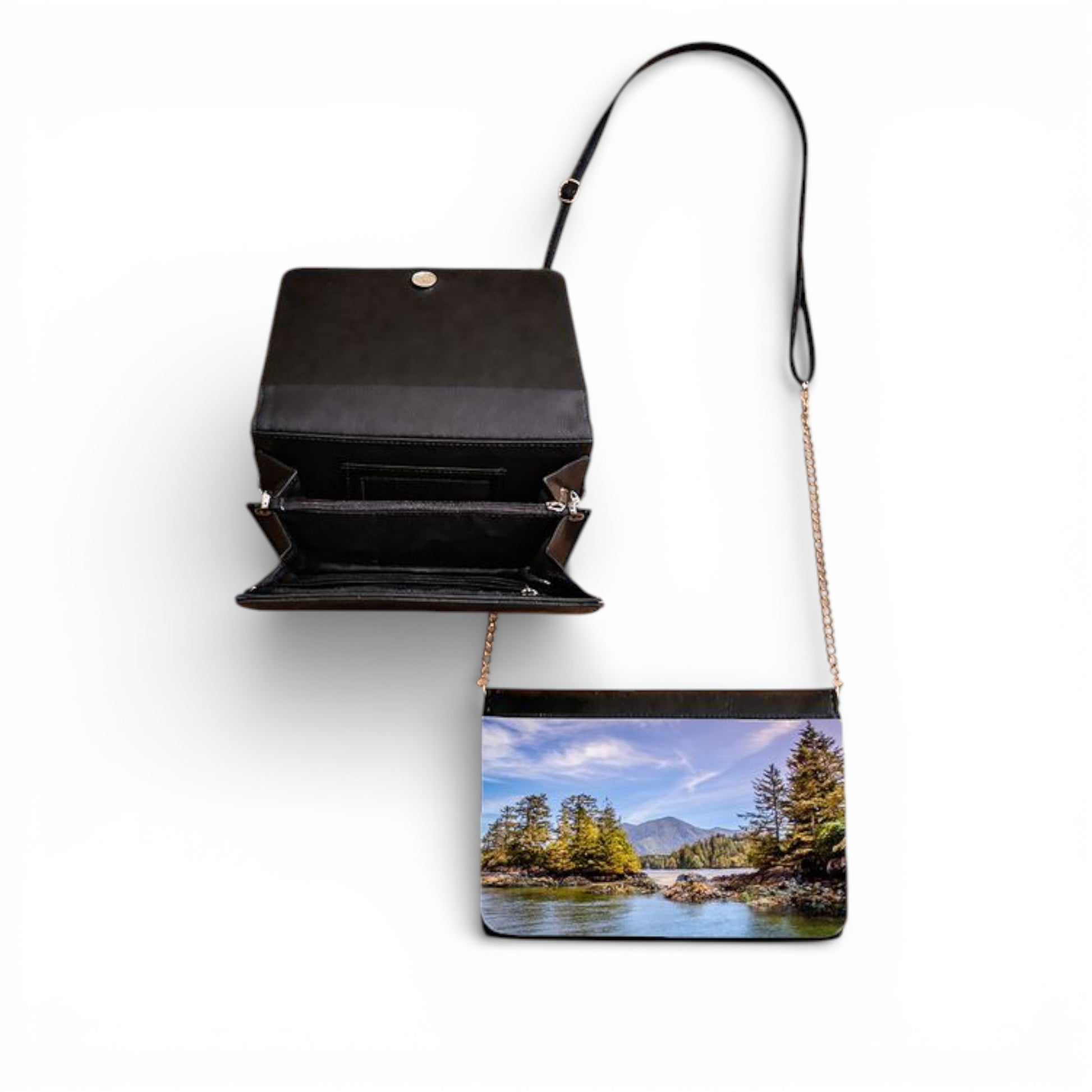 Black crossbody bag with a scenic print of a lake and trees on a white background