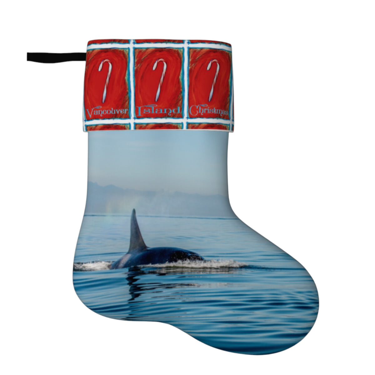 A Christmas stocking featuring a printed photograph of an orca whale in blue ocean water, with a red patterned cuff at the top showing three candy canes and the words Vancouver, Seattle, and Sydney.