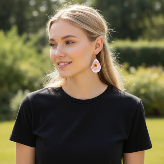 Woman wearing a black shirt and floral earrings outdoors