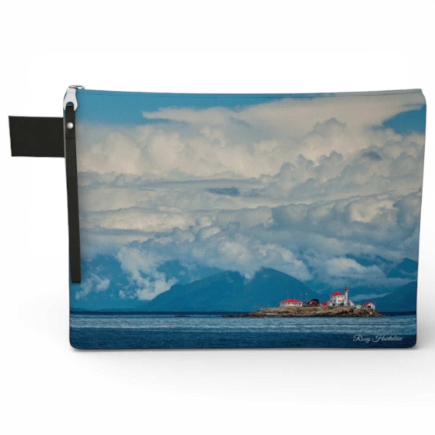 Pouch with a scenic design of a lighthouse on an island with clouds and water.