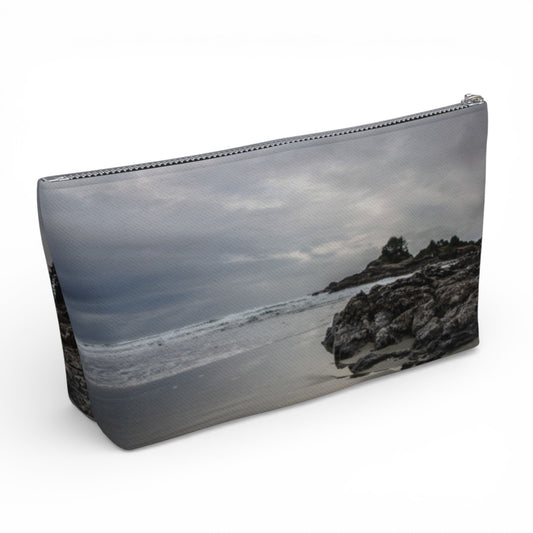 Pouch with a beach scene printed on it, featuring rocks and water.