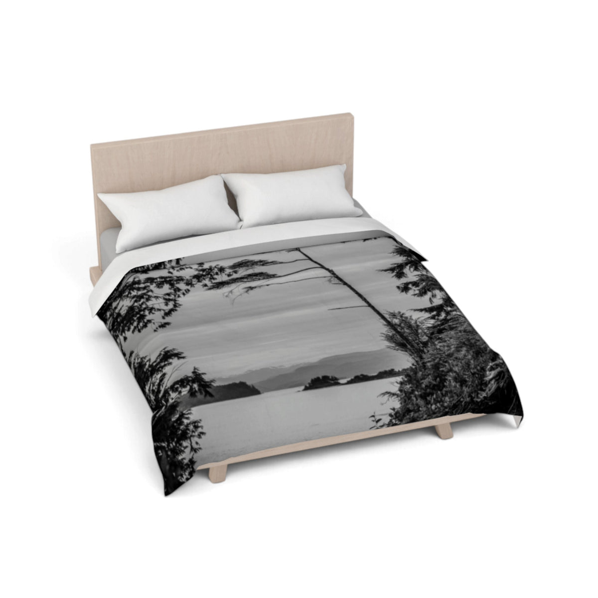 A bed with a black and white landscape print comforter, white pillows, and a light wood headboard on a clean white background.