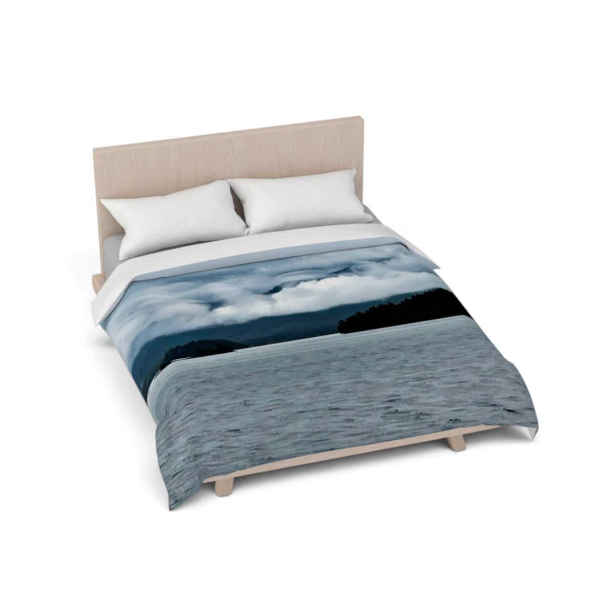A bed with a duvet cover featuring a scenic landscape print of a blue lake under cloudy skies, styled with two white pillows and a light wood headboard on a white background.