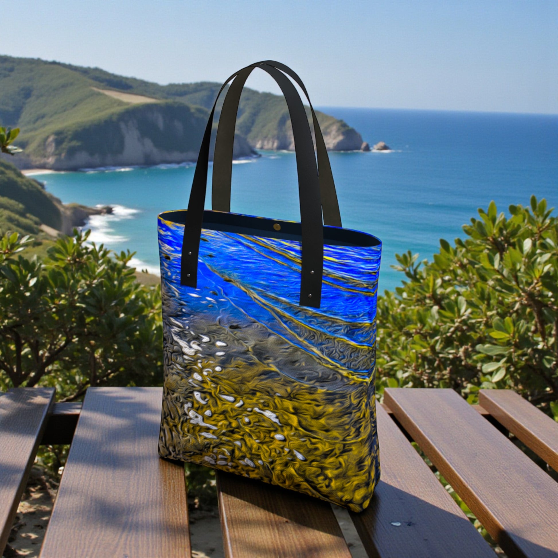 Tote bag with a scenic ocean view design on a wooden bench