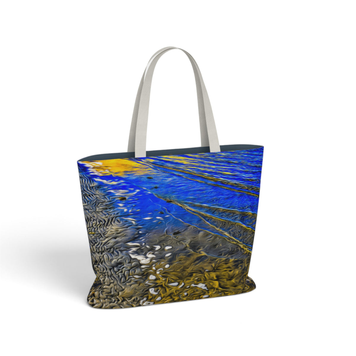 A tote bag with a water-ripple print in blue, gold, and gray, featuring light gray fabric handles, shown on a white background.
