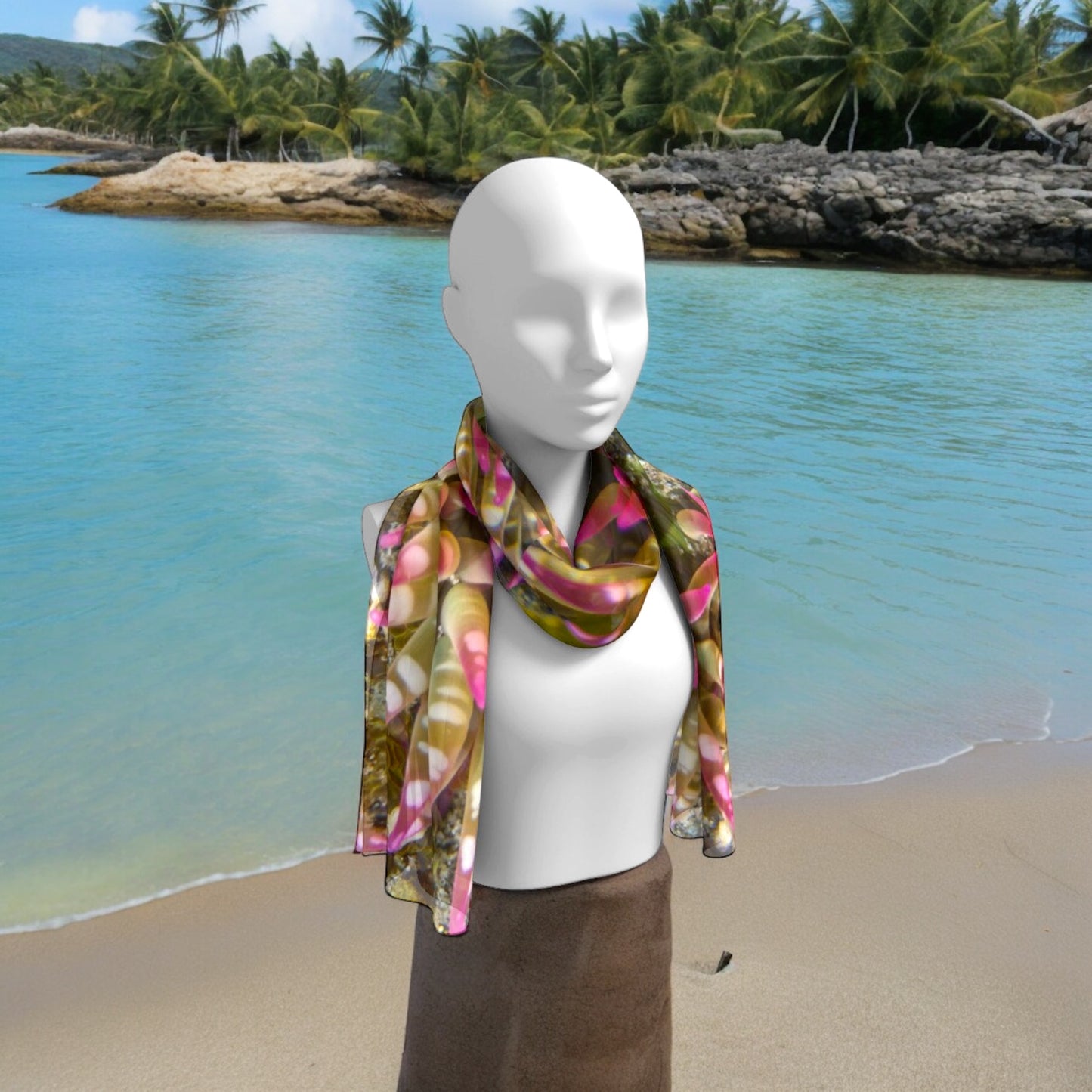 Pink Sea Anemone printed on a long scarf worn around the neck on a person at the beach.