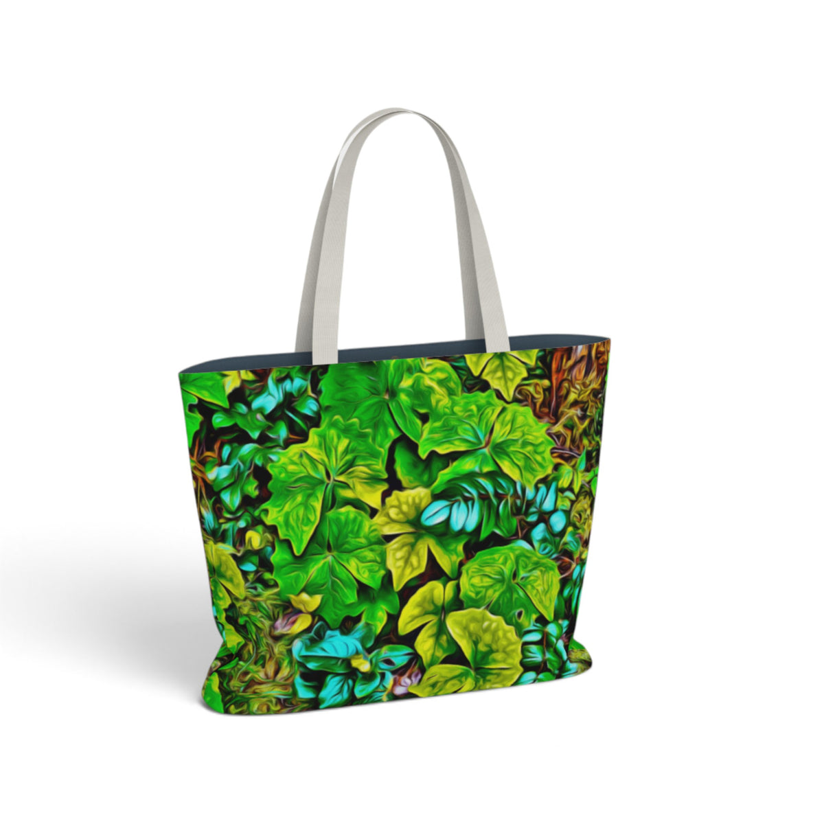 A tote bag featuring a vibrant green and blue leafy botanical pattern, with light gray shoulder straps, shown on a clean white background.