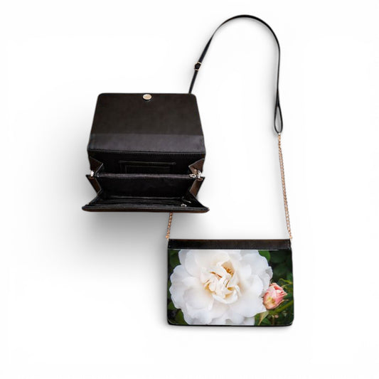 Black handbag with a floral design on a white background