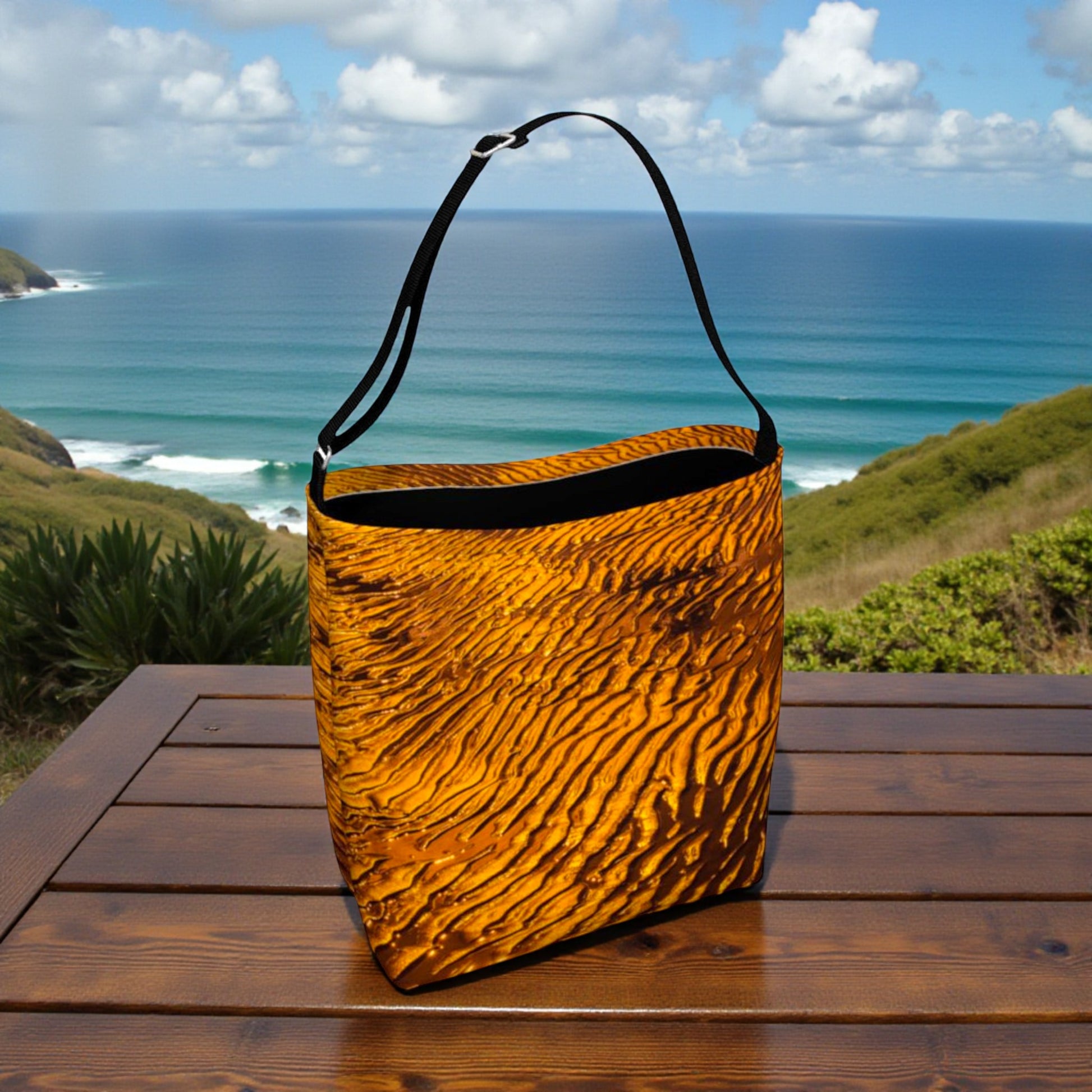 Brown textured bag on a wooden table with a scenic ocean view in the background