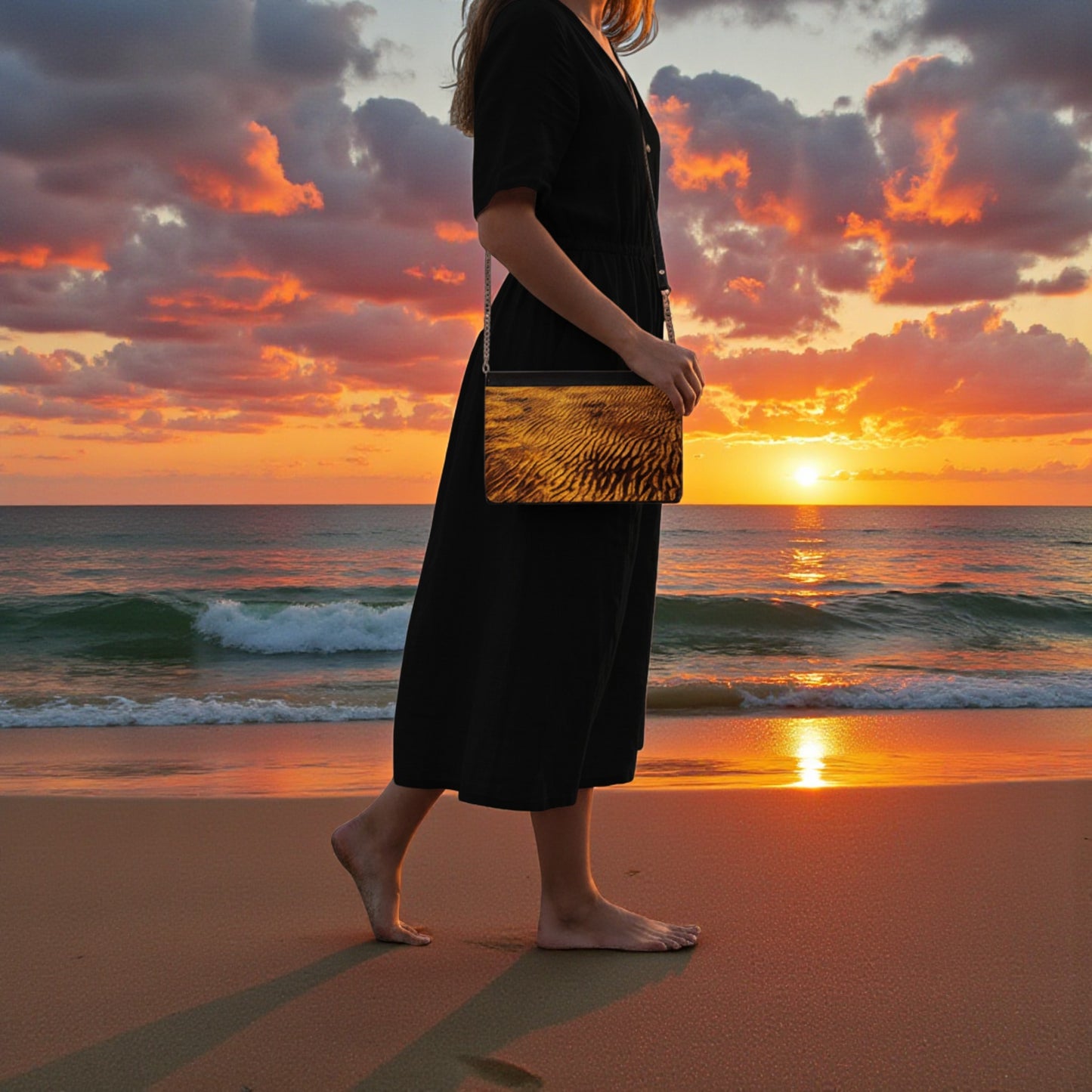 Person holding a clutch on a beach at sunset