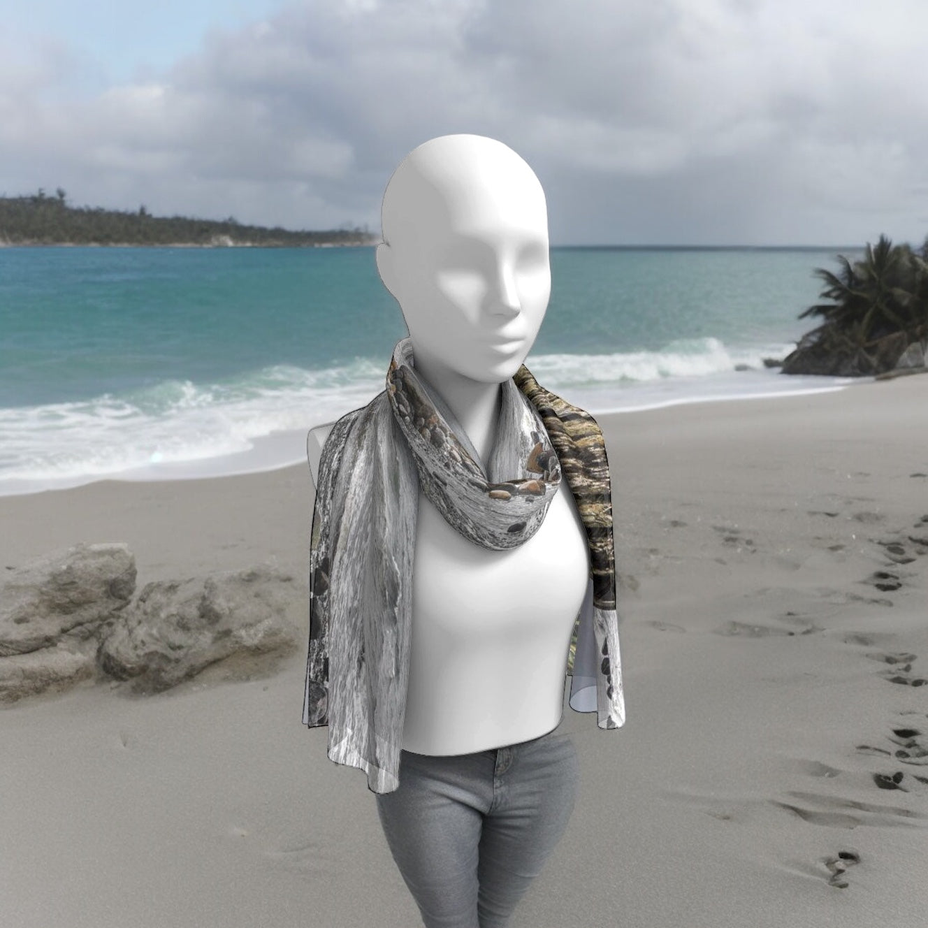 Gray Day Long Scarf worn around the neck of a person walking on the beach.