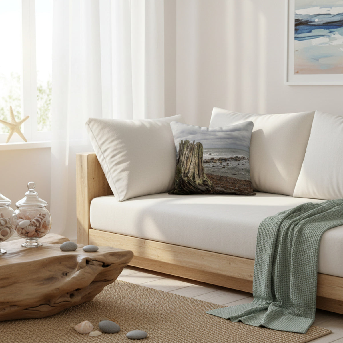 Beach theme pillow on a white sofa.