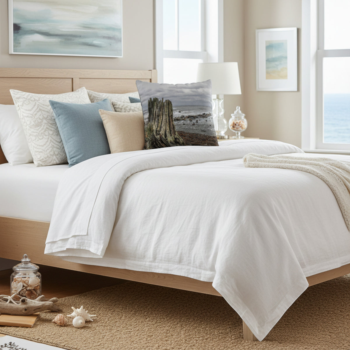Beach theme pillow on a queen bed.