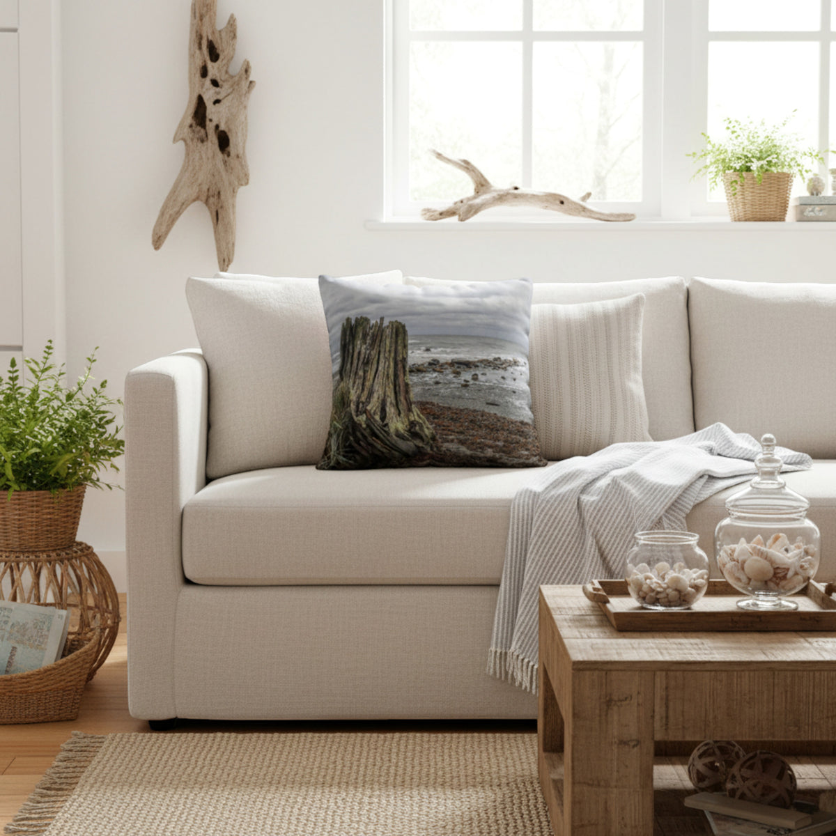 Beach theme pillow on a cream sofa.
