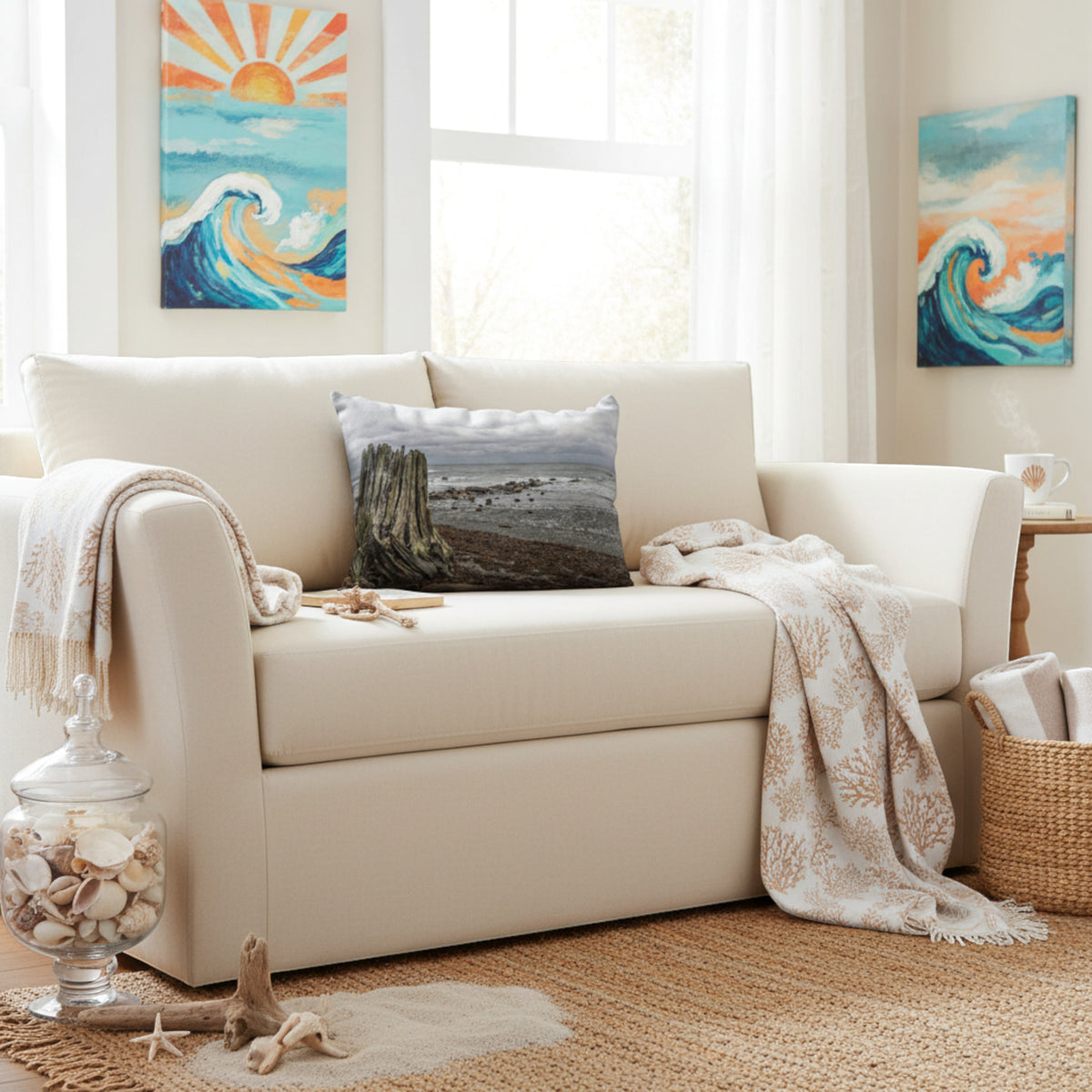 A throw pillow with an image of a tree stump on a beach with a cloudy sky in the background.
