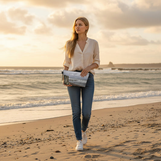 Woman walking on a beach with a sunset in the background