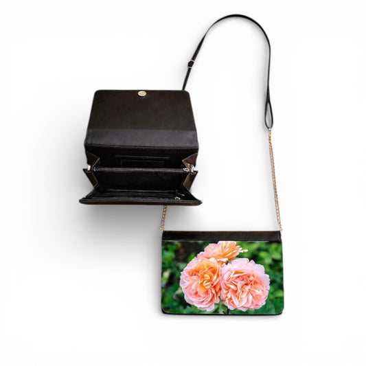Black handbag with a floral design on a white background