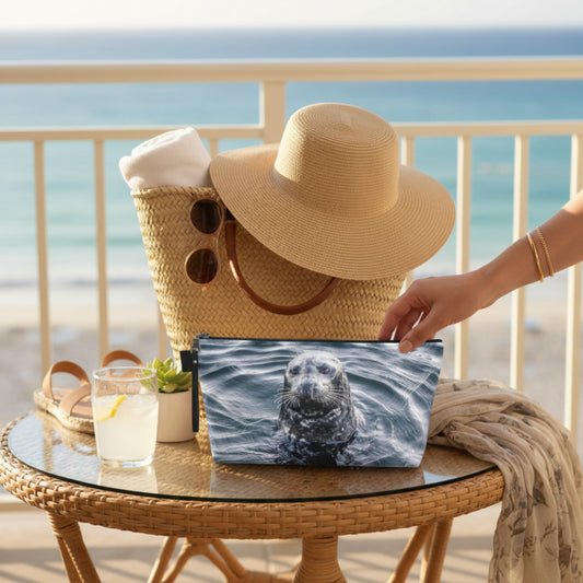 Straw bag with a hat and pouch on a table by the ocean