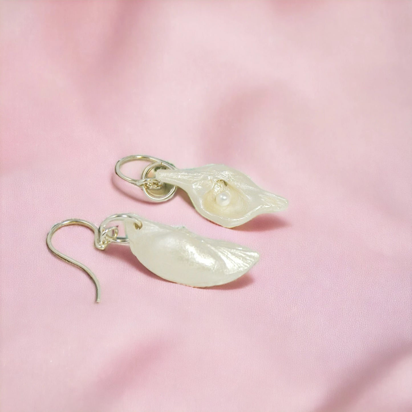 Harmony Earrings made of natural seashells and real freshwater pearls.  The pearls are shown on a pink background.