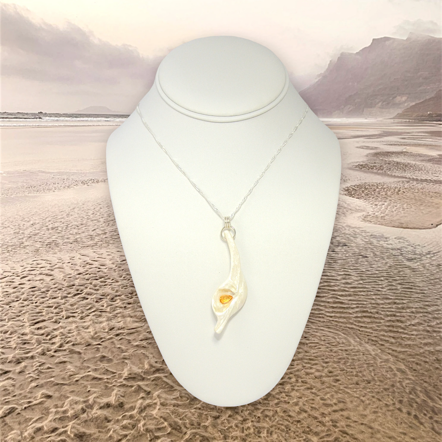 Sun Star natural seashell pendant with a beautiful pear shaped rose cut Citrine. A misty ocean background.