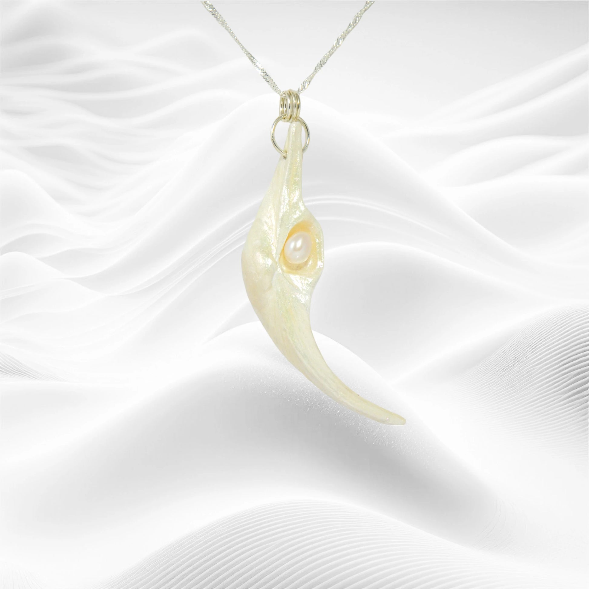 Jupiter is a natural seashell pendant with a real freshwater pearl.