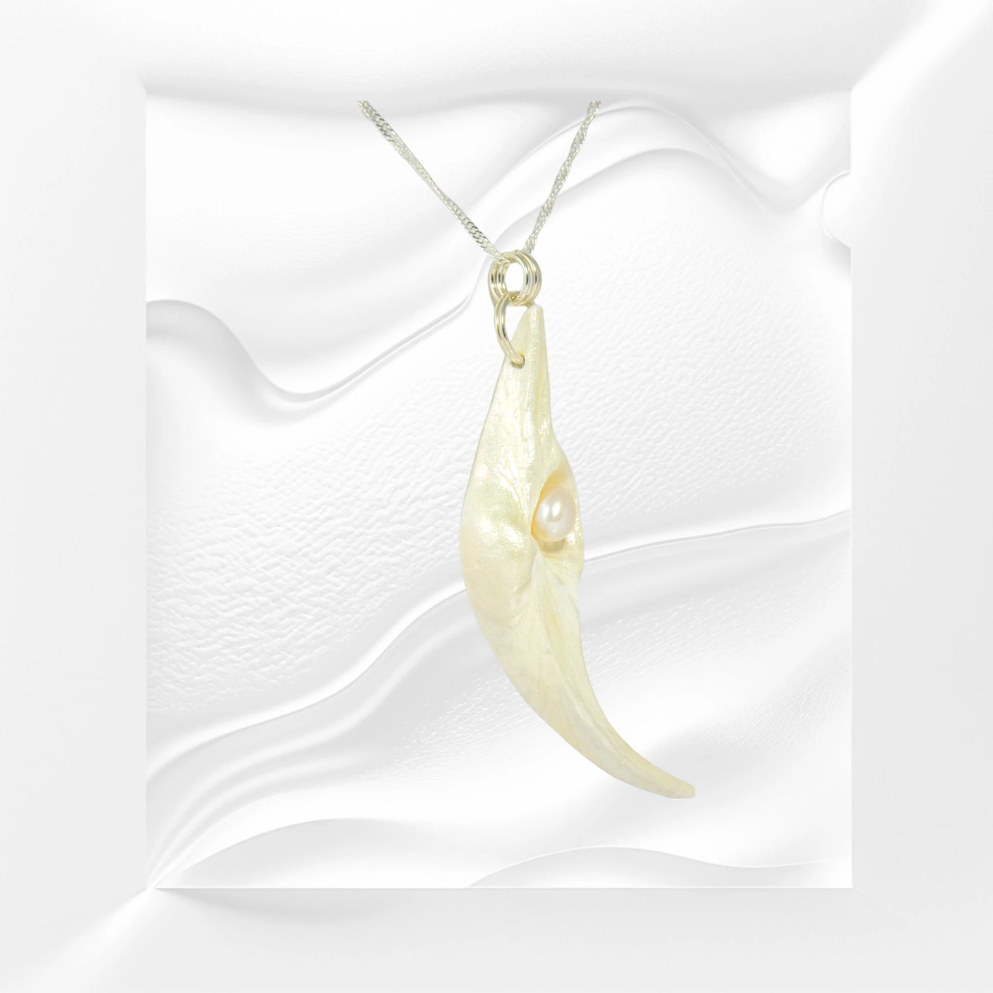 Jupiter is a natural seashell pendant with a real freshwater pearl.