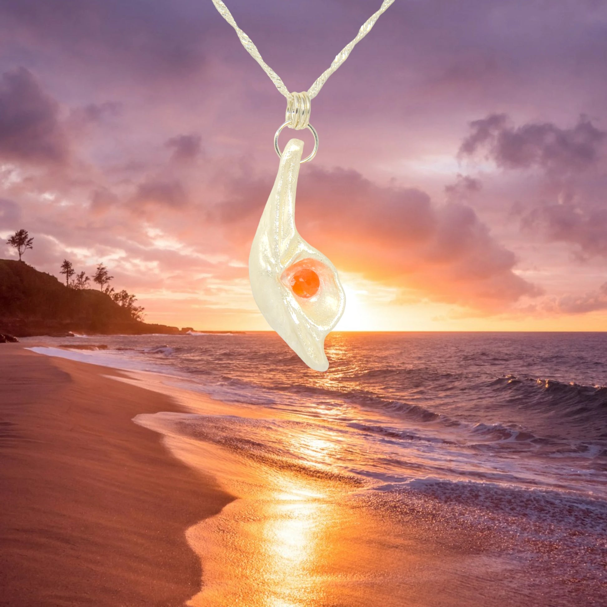 Natural Seashell pendant, elevating the beautiful natural nuances to new heights. The pendant is perfectly adorned with a mesmerizing rose cut Carnelian gemstone. The background is a sunset over the ocean.