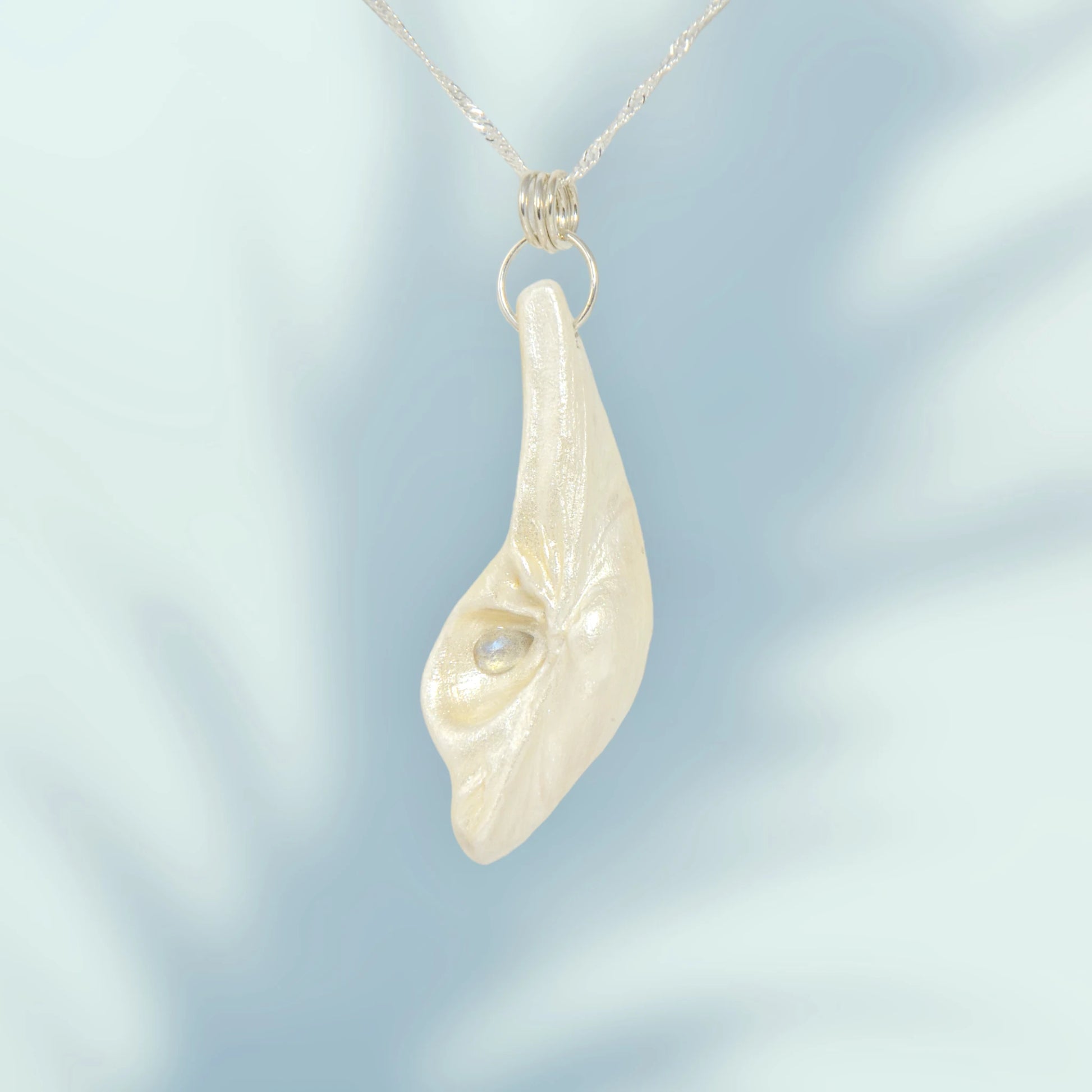 Cool Summer pendant made of natural seashell with a tear drop shape rose cut labradorite gemstone. 
