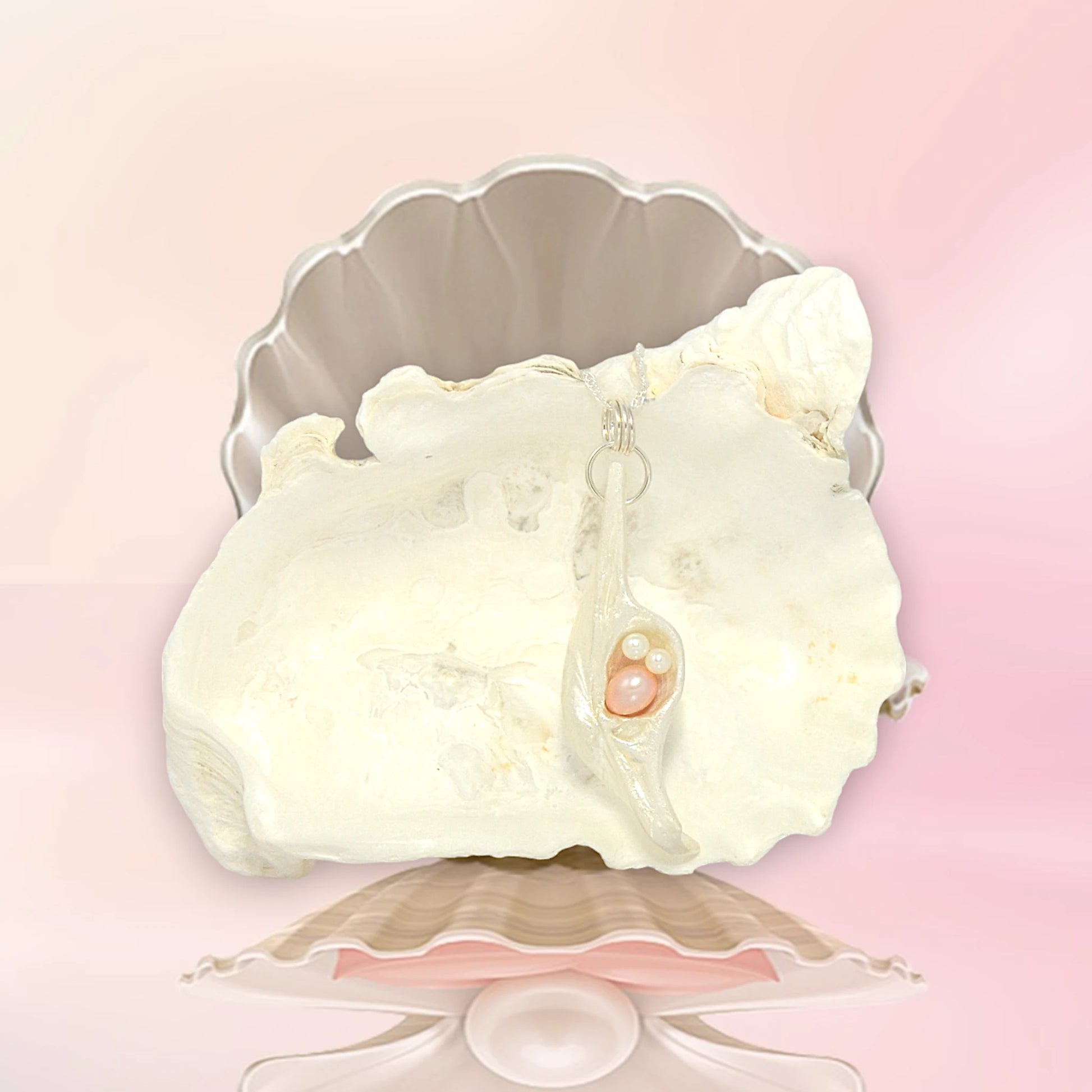 This natural seashell pendant has a real 7-8mm pink freshwater pearl and two baby pearls.