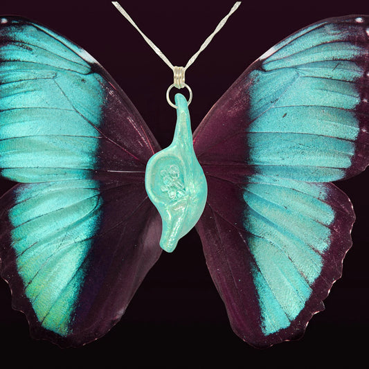 Diamond Mine Pendant is named for the eight herkimer diamonds that enhance the beauty of this gorgeous pendant!  Background is of a turquoise and black butterfly.  The Diamond Mine pendant hangs in the middle of the butterfly.