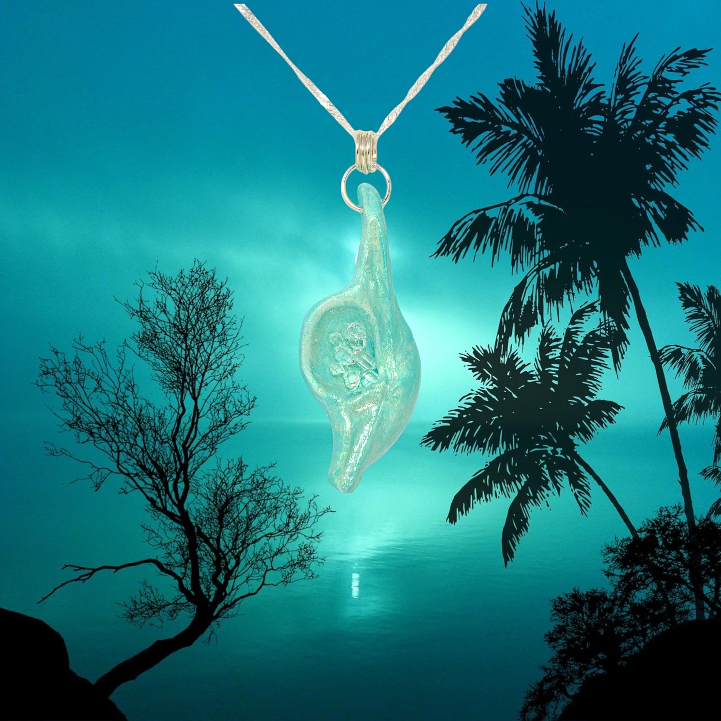 Diamond Mine Pendant is named for the eight herkimer diamonds that enhance the beauty of this gorgeous pendant!  The pendant is shown hanging from a chain over a moon lit ocean with trees around.