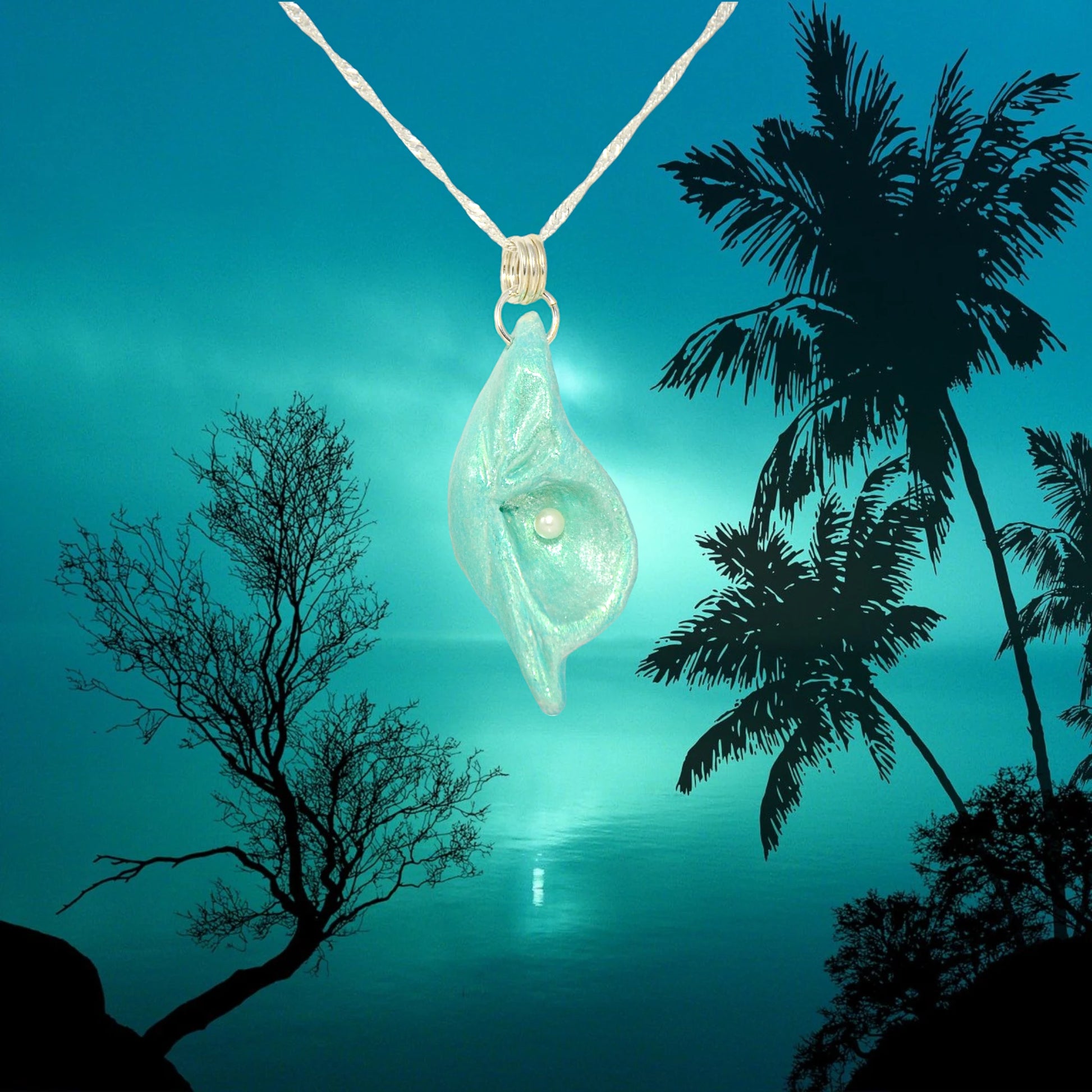 Ocean Pearl natural seashell pendant has a  real freshwater baby pearl. The background is of the ocean at night.
