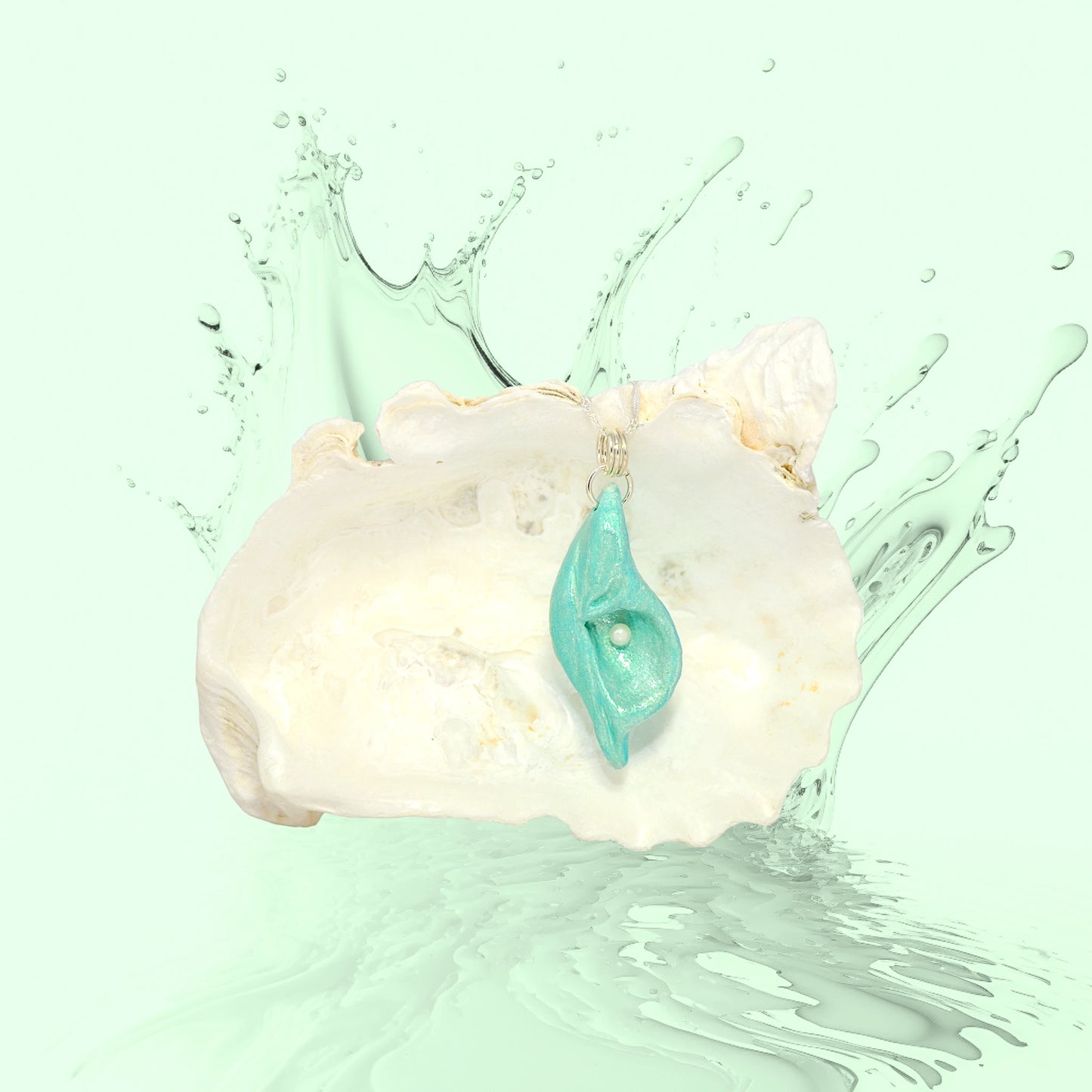 Ocean Pearl natural seashell pendant has a  real freshwater baby pearl.  The pendant is shown in front of a larger seashell that appears to be making a splash in sea green water.