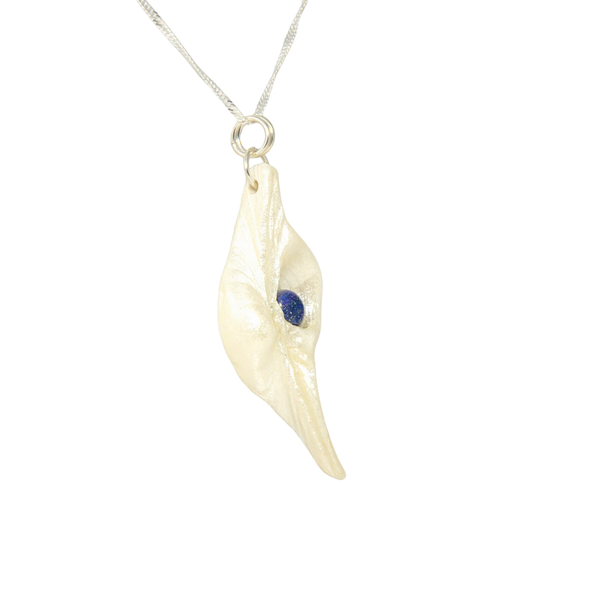 Vision is a natural seashell pendant with a Lapis Lazuli gemstone. 