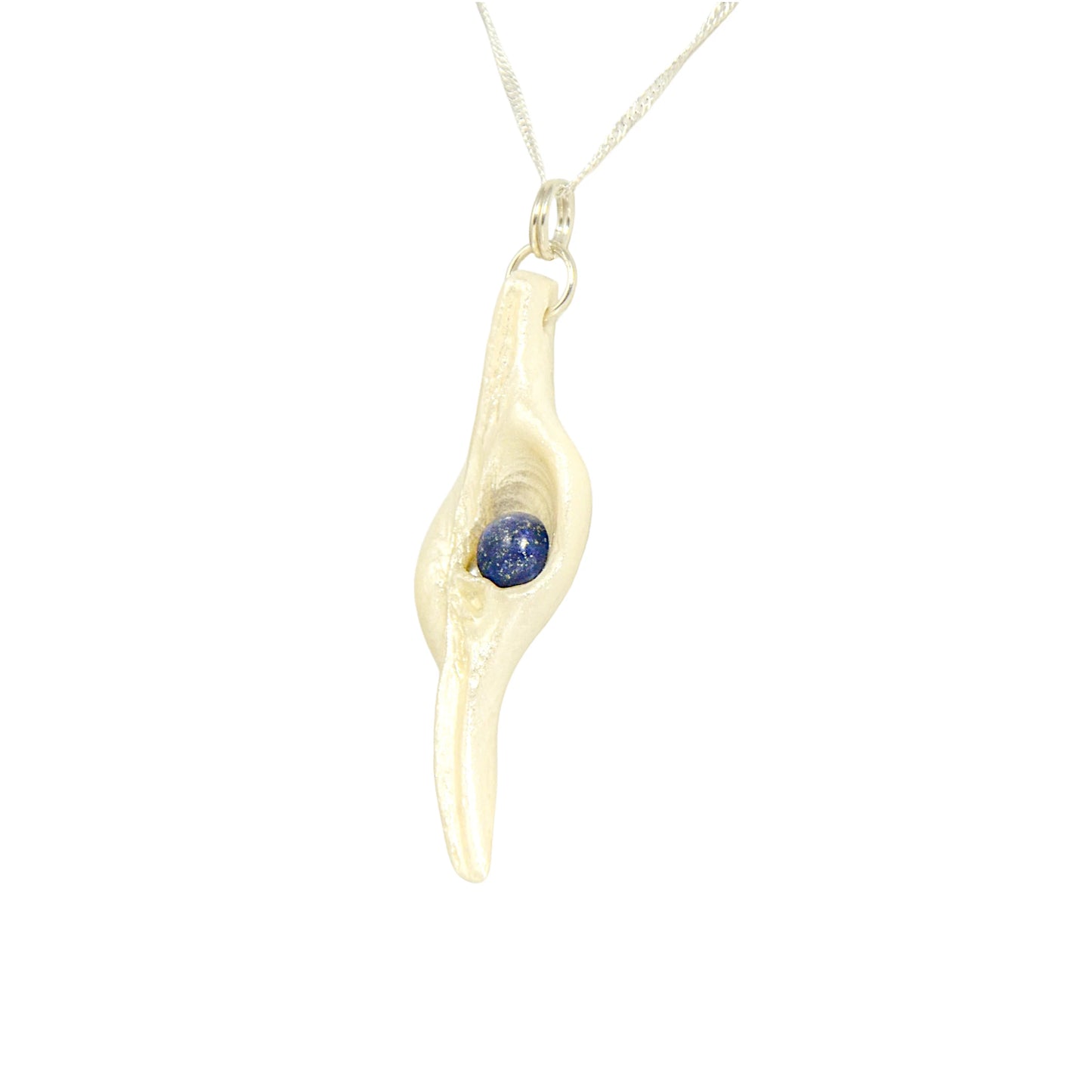 Vision is a natural seashell pendant with a Lapis Lazuli gemstone. 
