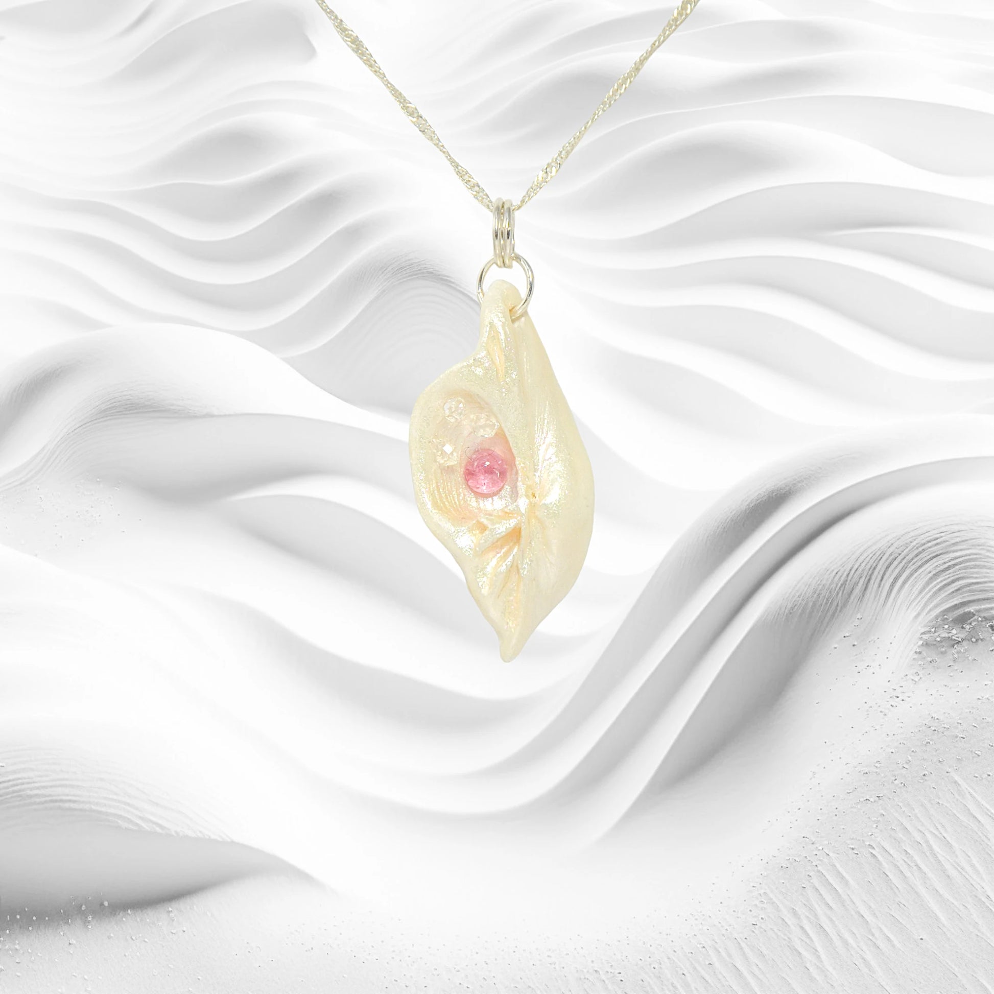 This natural seashell pendant has Pink Tourmaline gemstone and three Herkimer Diamonds that compliments the pendant.