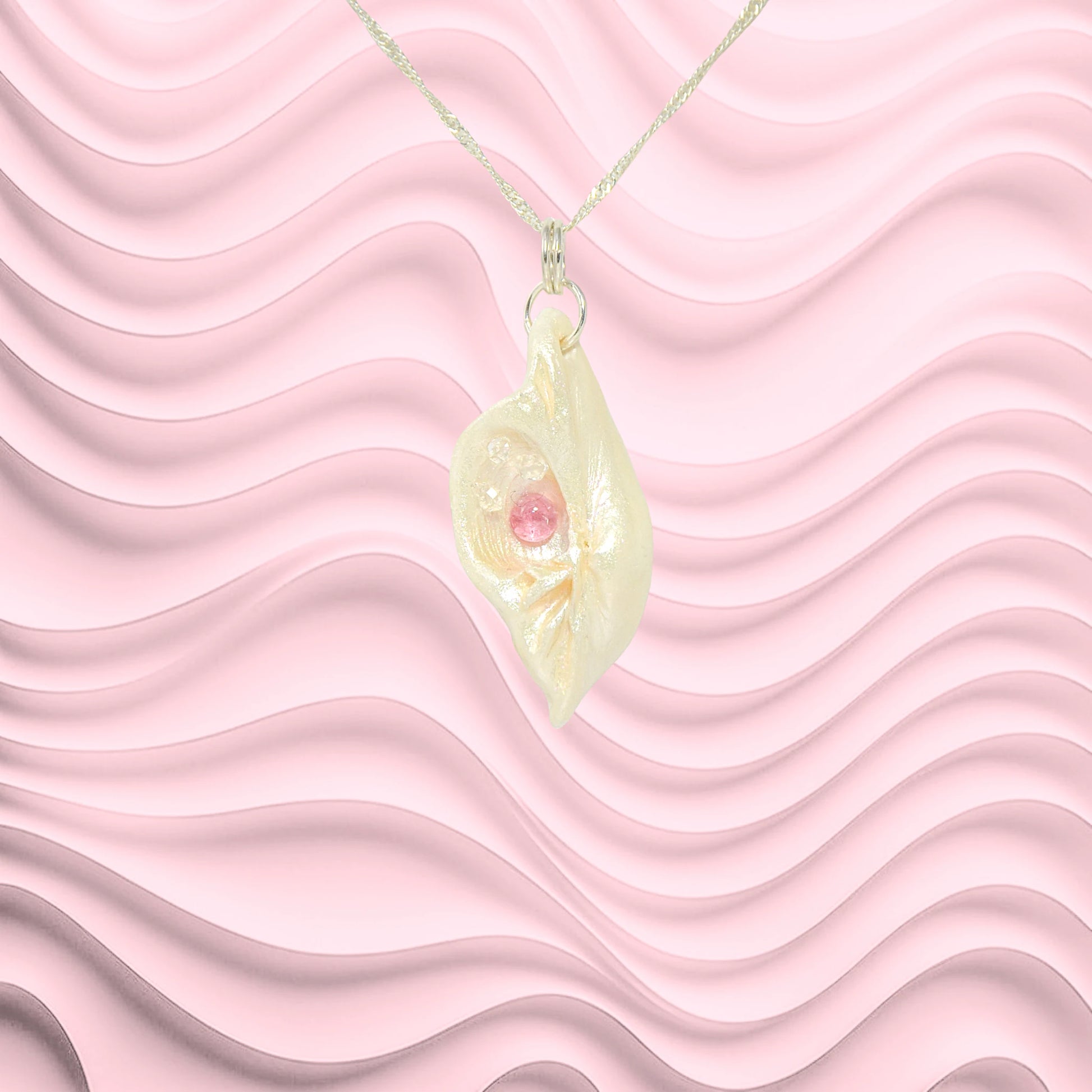 This natural seashell pendant has Pink Tourmaline gemstone and three Herkimer Diamonds that compliments the pendant.