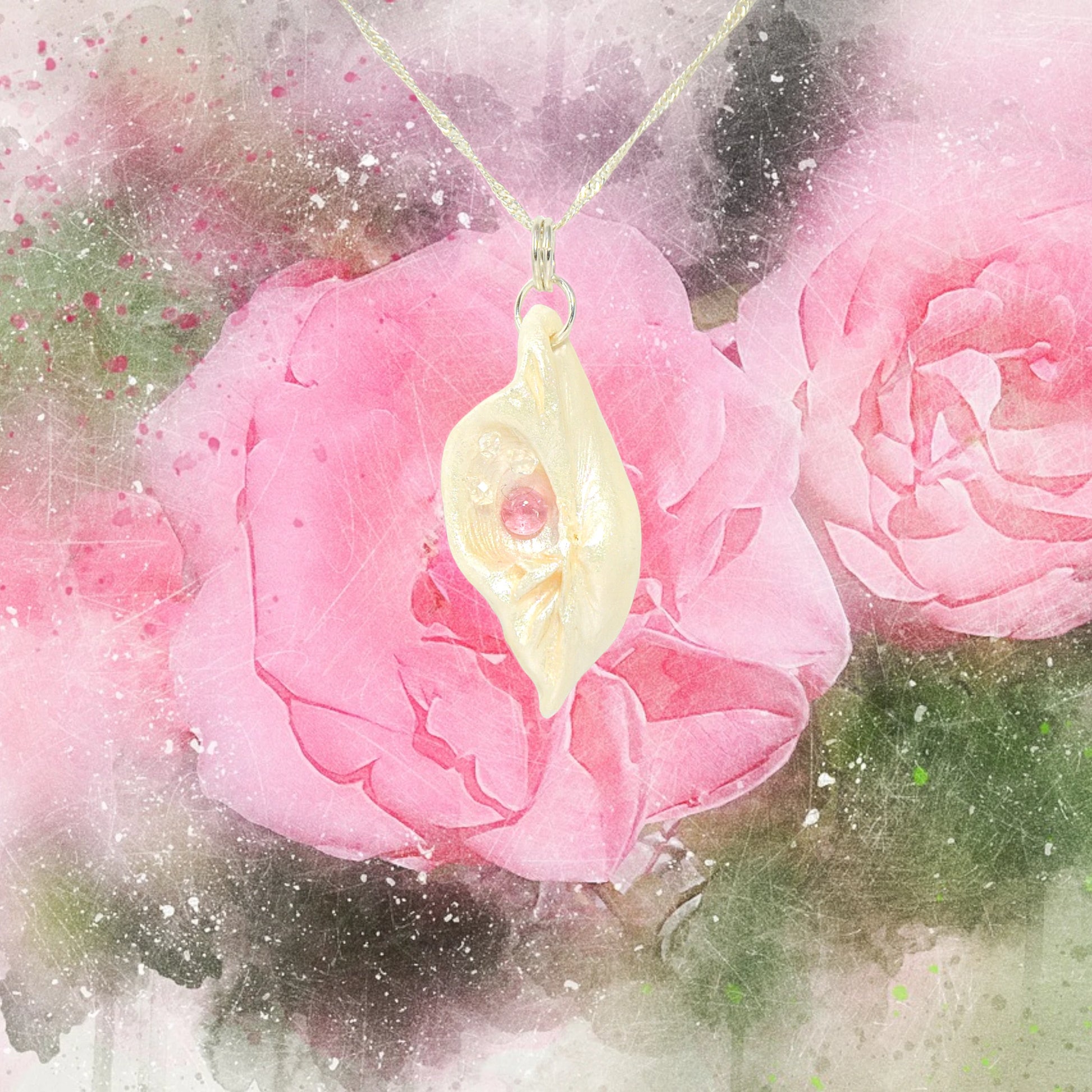 This natural seashell pendant has Pink Tourmaline gemstone and three Herkimer Diamonds that compliments the pendant. The pendant is shown with a pink rose background.