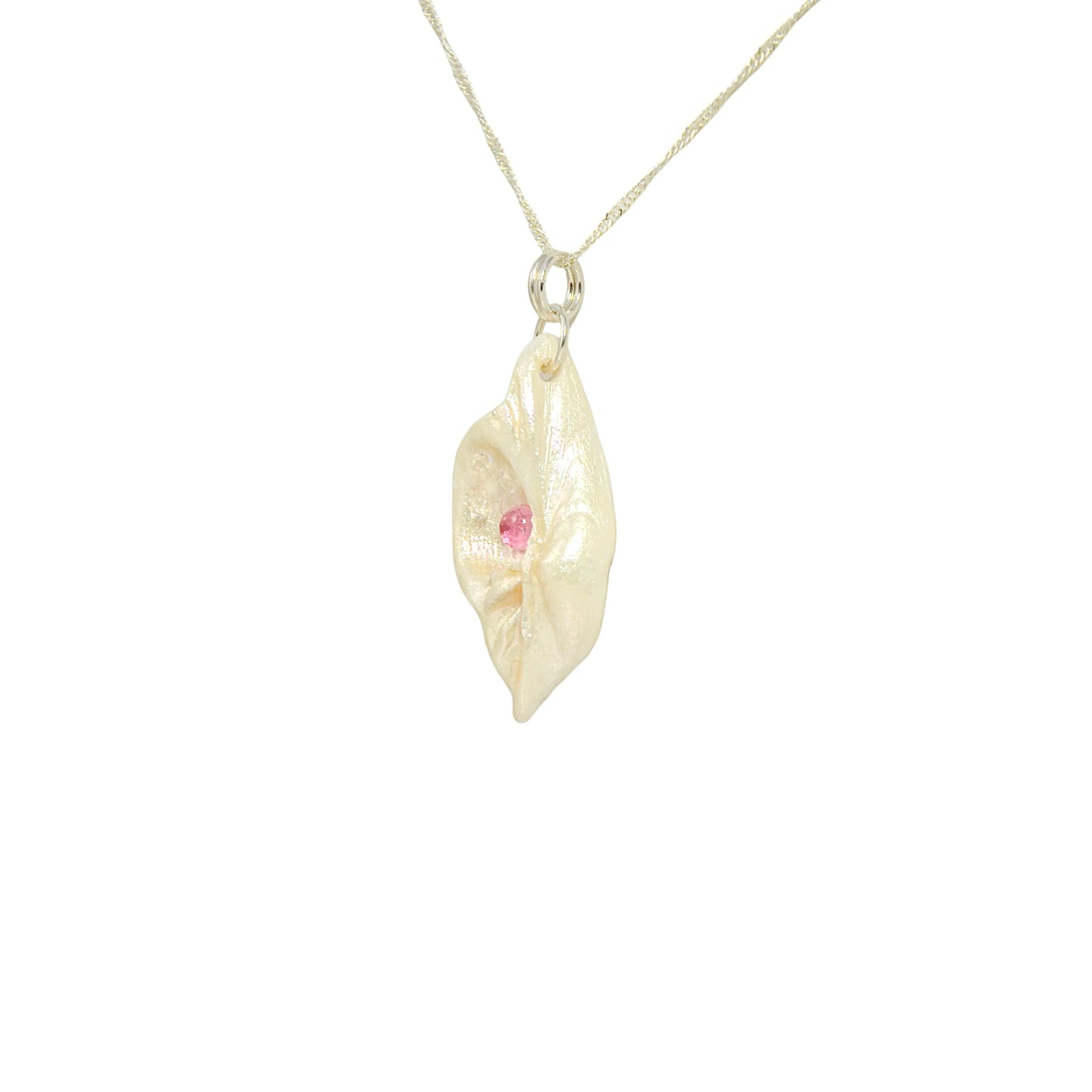 This natural seashell pendant has Pink Tourmaline gemstone and three Herkimer Diamonds that compliments the pendant. The pendant is turned to show the viewer the left side of the pendant.
