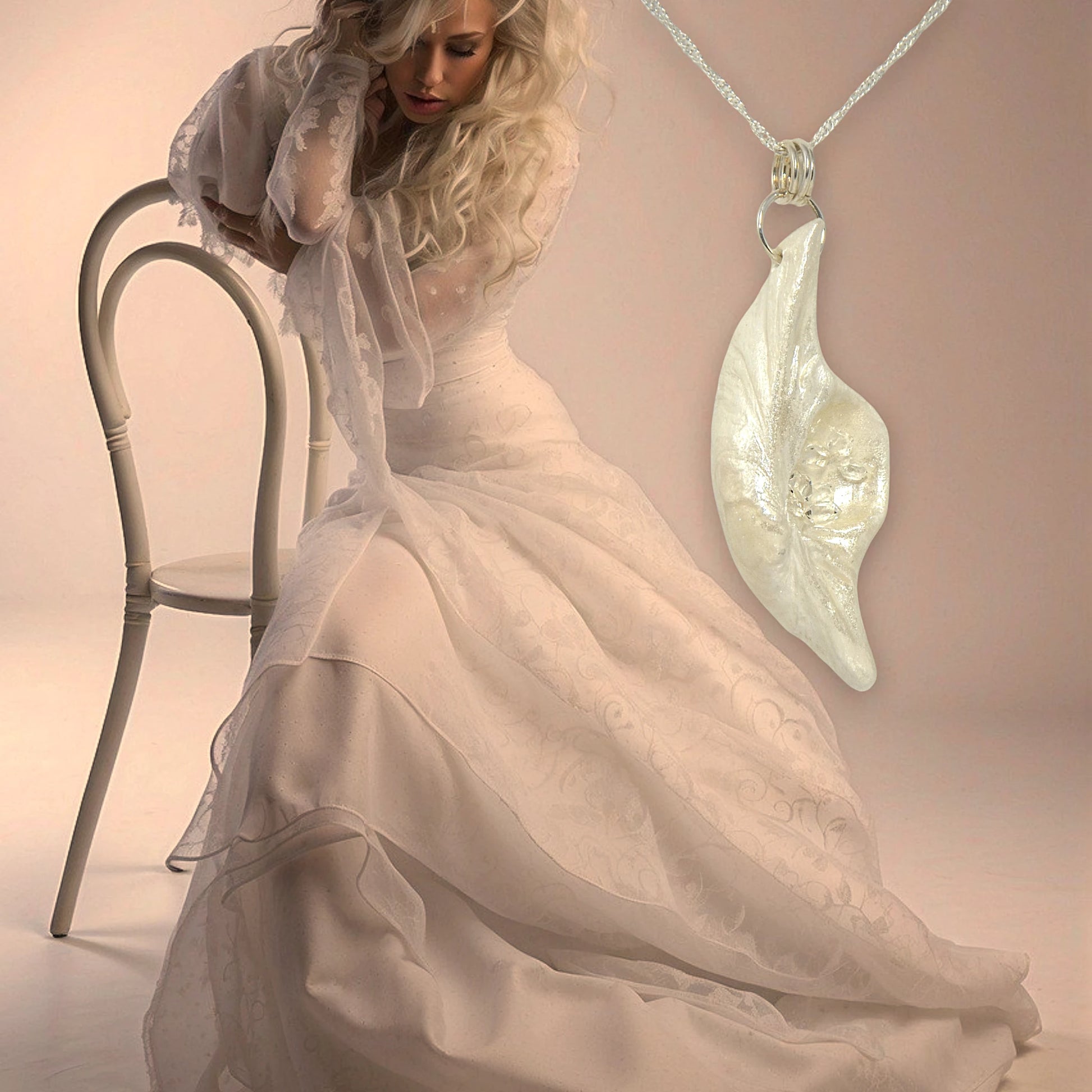 Beautiful pendant called Clarity.  Clarity is a natural seashell from the beach of Vancouver island.with seven herkimer diamonds. The pendant is shown hanging from a chain on the right side of the image.  On the left side is a woman wearing a long wedding gown.