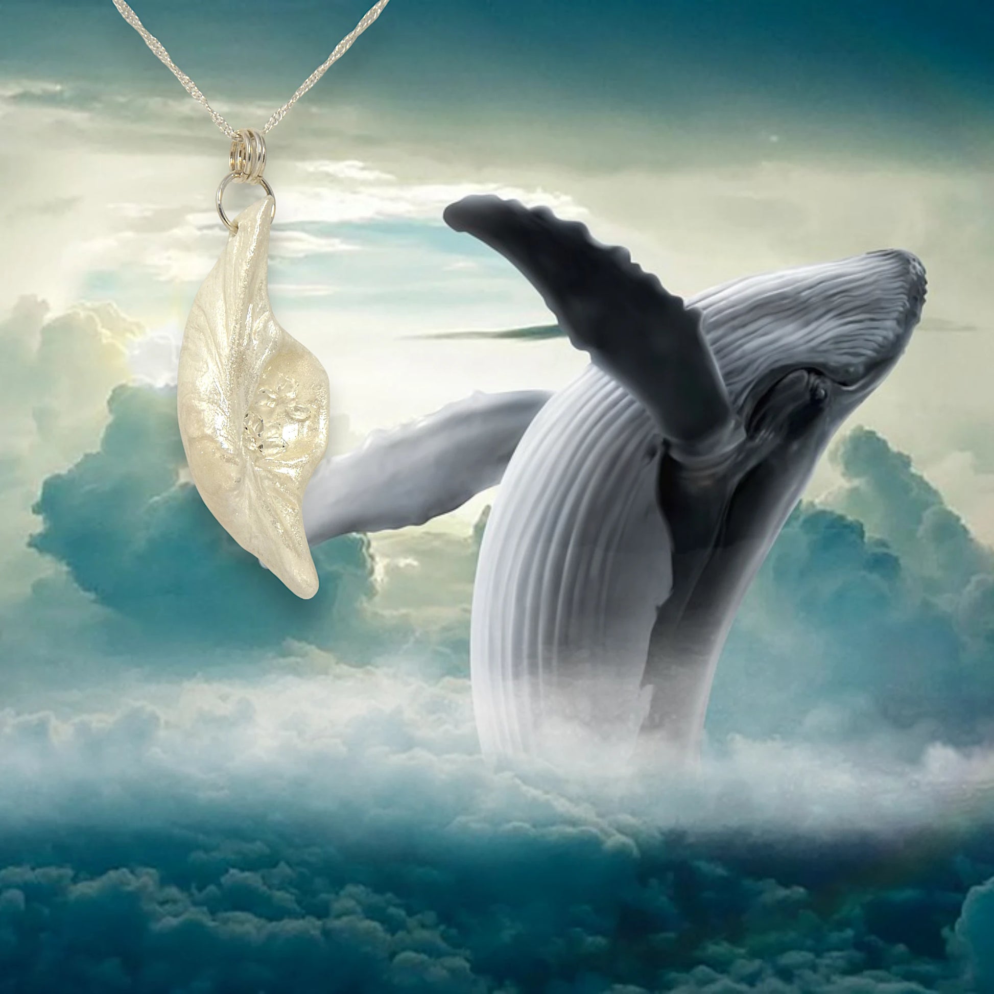 Beautiful pendant called Clarity.  Clarity is a natural seashell from the beach of Vancouver island.with seven herkimer diamonds. The pendant is shown hanging from a chain at the top of the left side of the image.  the background is of a breaching humpback whale.  