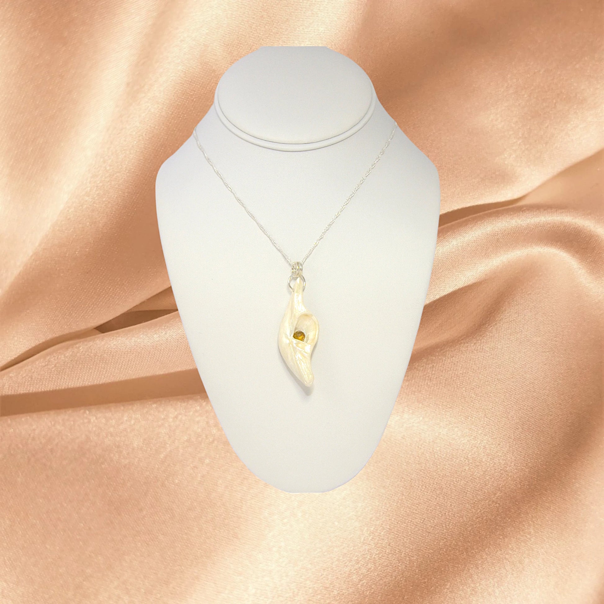 Seer is a natural seashell pendant with a beautiful 5mm rose cut Smokey Quartz compliments the pendant.