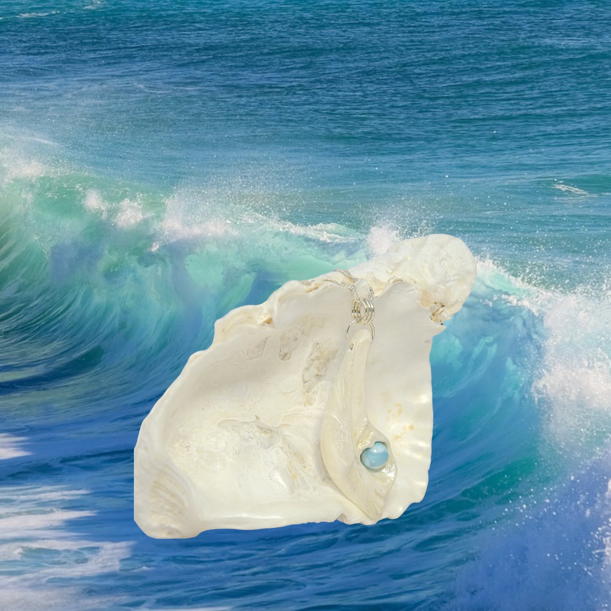 Larimar Moon natural seashell a beautiful 10 mm Round Larimar Gemstone compliments the pendant. The background is of a ocean wave.