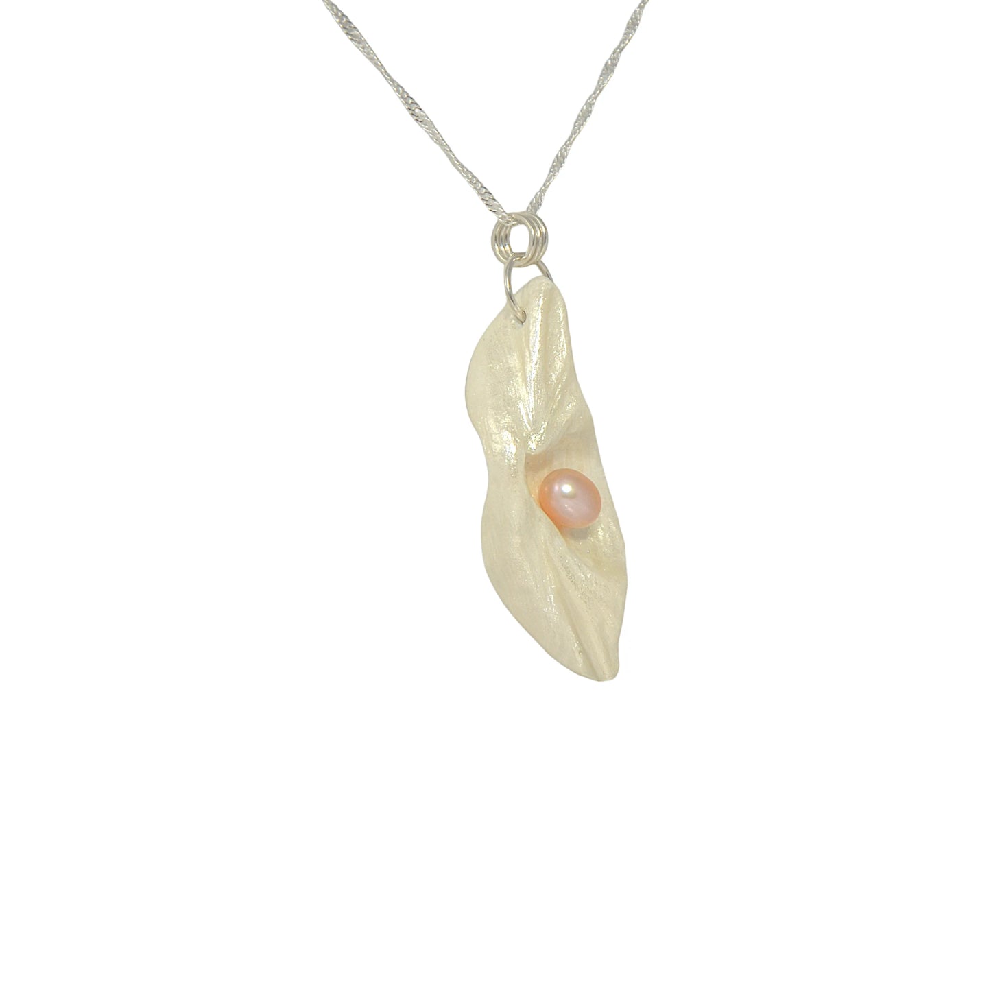 Glow natural seashell pendant with a pink freshwater pearl.  The pendant is turned so the viewer can see the right side of the pendant.