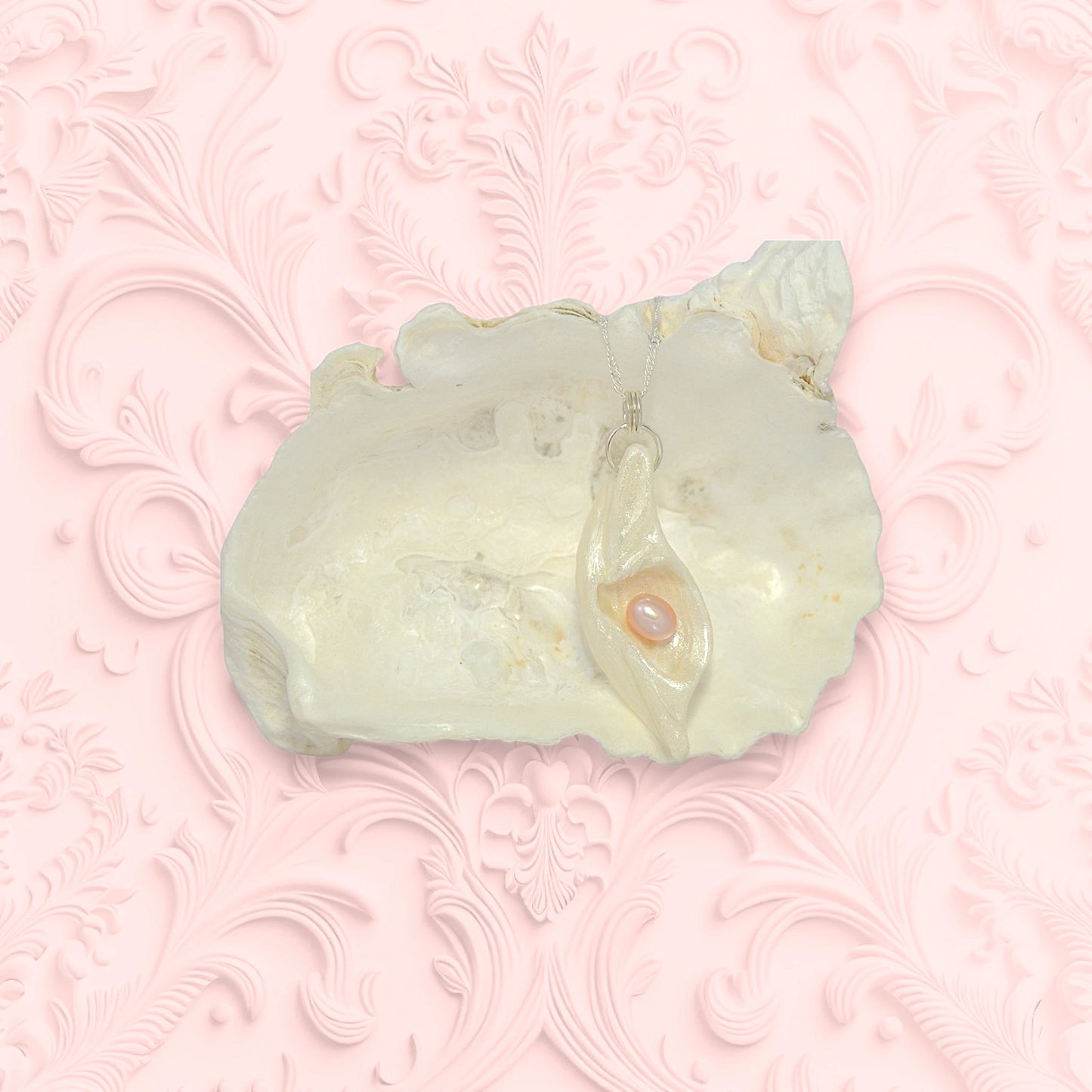 Glow natural seashell pendant with a pink freshwater pearl. 