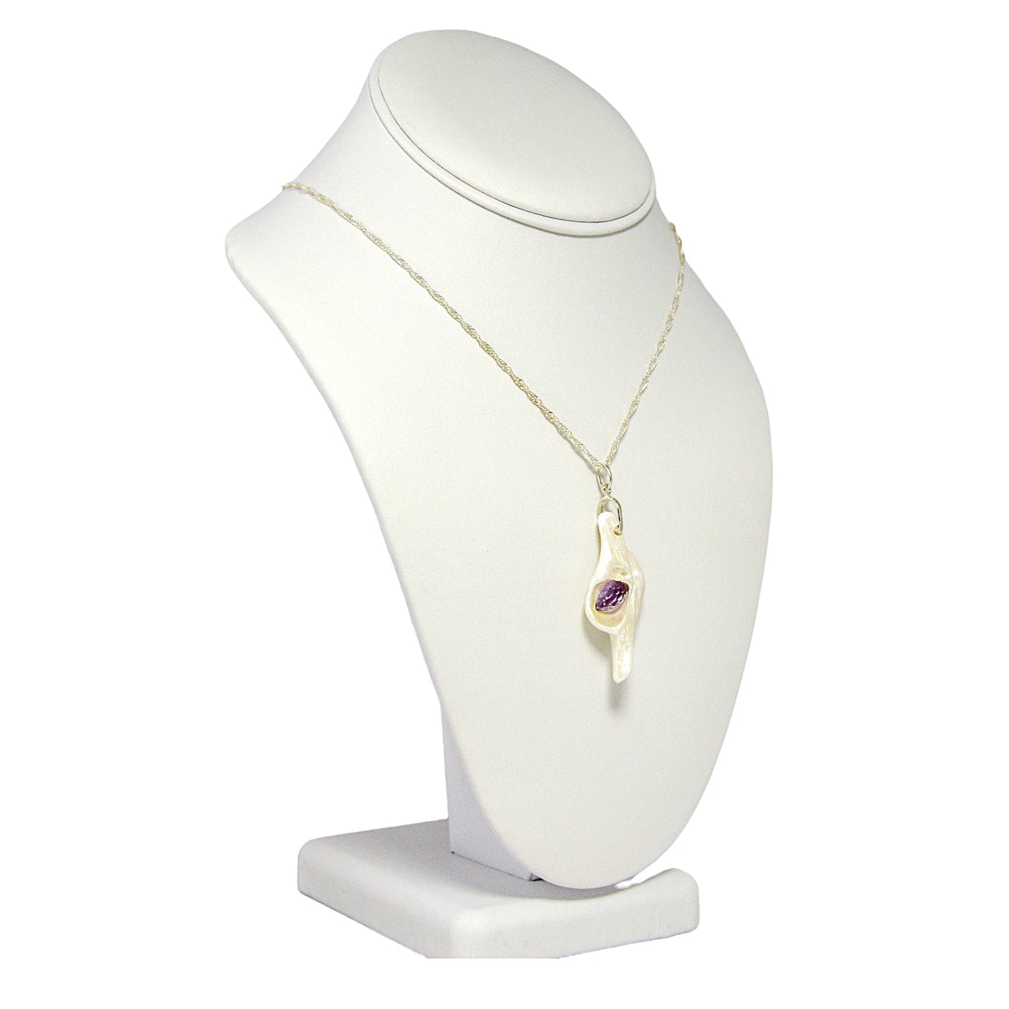 Intuition a natural seashell pendant with a beautiful rose cut marquise Amethyst. The pendant is turned so the viewer can see the right side of the pendant.