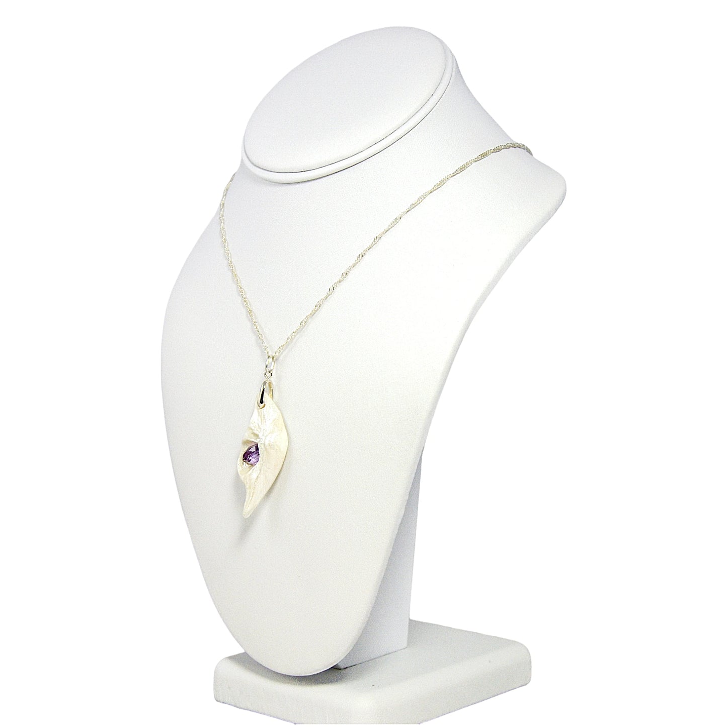 Intuition a natural seashell pendant with a beautiful rose cut marquise Amethyst.  The pendant is shown turned so the viewer can see the left side of the pendant.