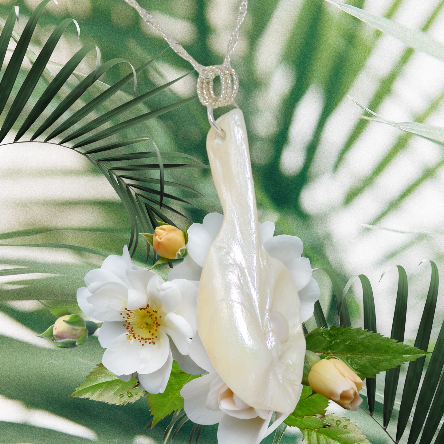 Amara is the name of this one of a kind pendant made from a natural seashell from the beach of Vancouver Island.  The pendant has a real freshwater pearl.  The pendant is being showcased showing the right side of the pendant.